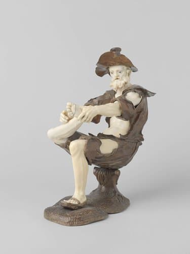 Zittend bedelende figuur