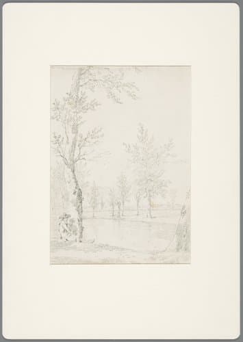 Zittende man naast een boom aan het water