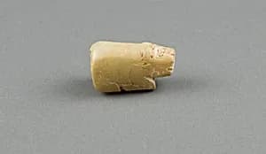 Bead, crouching buffalo. by Unknown