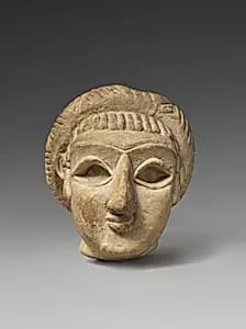 Female head with elaborate hairstyle by Unknown Artist