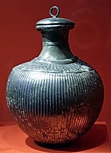 Fluted bottle with ring-handled lid by Unknown Artist