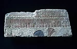 Relief with man carrying papyrus bundle by Unknown Artist