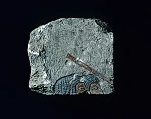 Relief with two heads and a stick by Unknown Artist