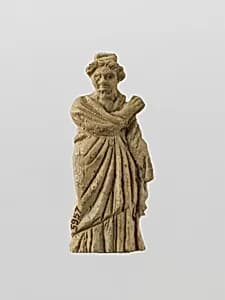 Bone statuette of a draped woman by Unknown Artist