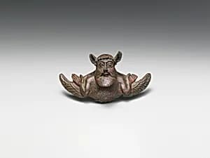 Bronze helmet attachment by Unknown Artist