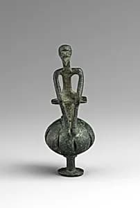 Bronze man seated on a ball by Unknown Artist