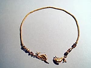 Gold chain with dolphins and glass beads by Unknown Artist