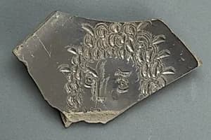 Plate with face, fragmentary by Unknown Artist