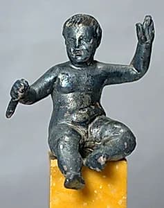 Silver statuette of a seated boy by Unknown Artist