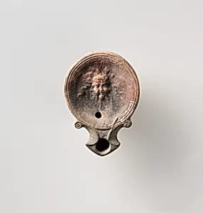 Terracotta oil lamp by Unknown Artist