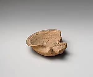 Terracotta saucer-shaped oil lamp by Unknown Artist