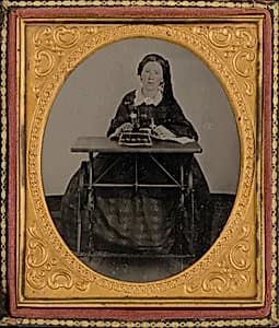 Portrait of a Woman with Sewing Machine by American 19th Century