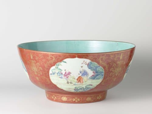 Straigh-sided bowl with playing boys in shaped panels on a red ground with floral scrolls by anonymous
