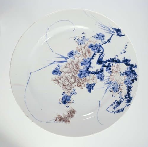 Plate with flowers, grass and flowering branches by anonymous