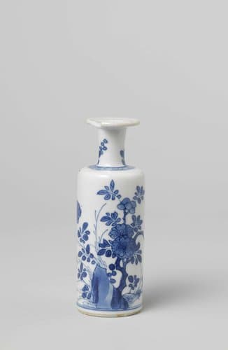 Small cilindrical vase with a flowering plant near a rock by anonymous