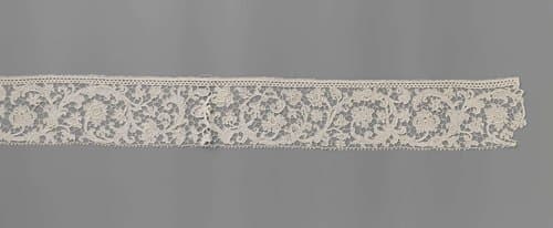 Strook naaldkant met voluutranken by anonymous