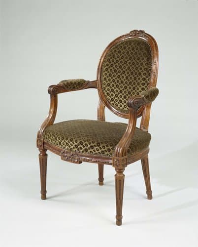 Armstoel van mahoniehout, met conische, gecanneleerde poten en op voorzitregel versierd met een strik. Bekleed met groene velours met patroon van rozetten. Bekleding niet origineel. by anonymous