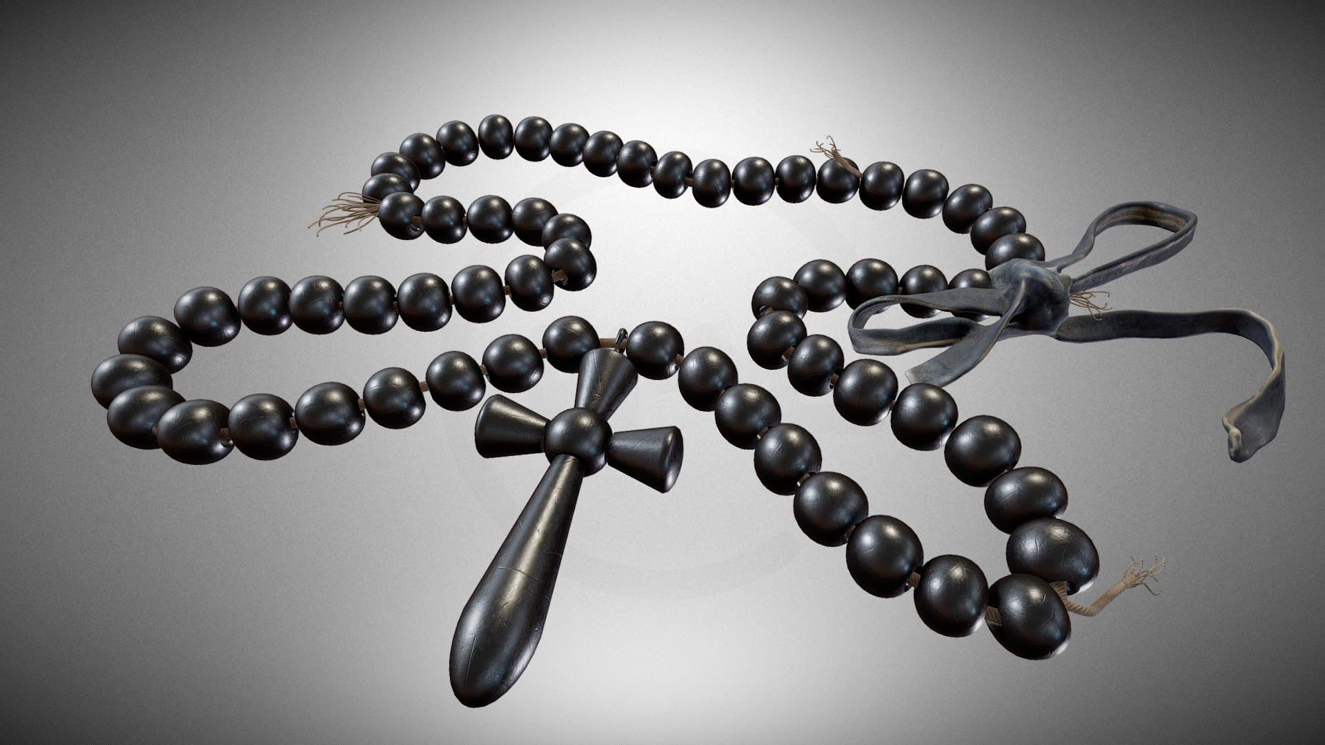 A black pendant with a cross – a prop