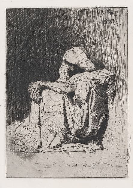 An Arabic man seated on the ground, head partly covered