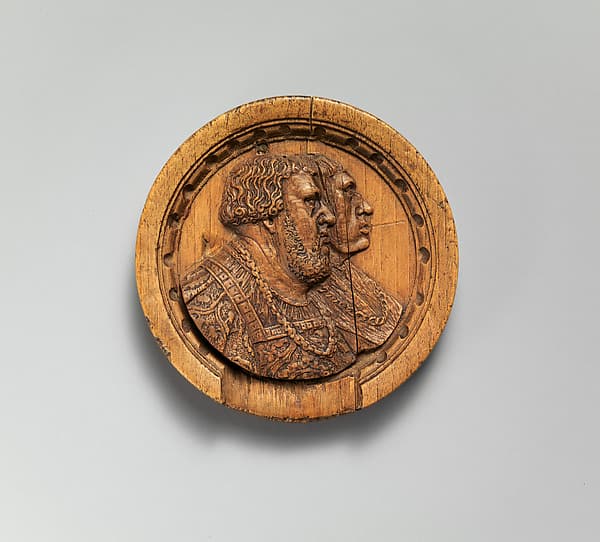 Game piece with two noblemen in profile