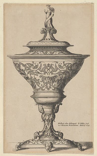 Ornate goblet on feet of masks