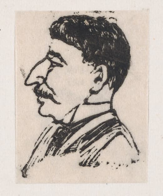 A profile of a man with a dark mustache and big nose
