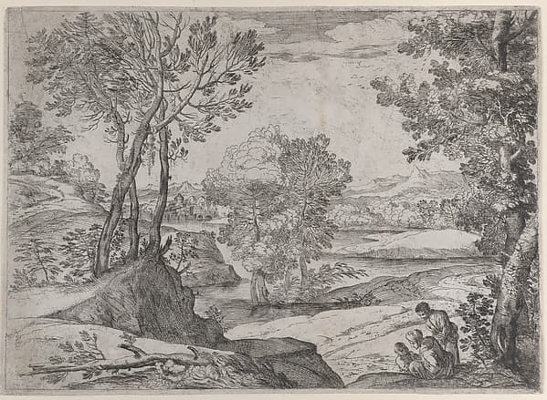 A family seated alongside a river