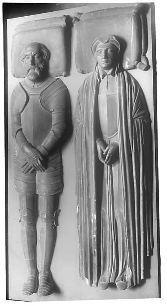 A man in armor and his wife in a long cloak (possibly Huguenots)